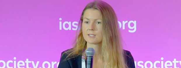 Woman speaking into a microphone at a conference